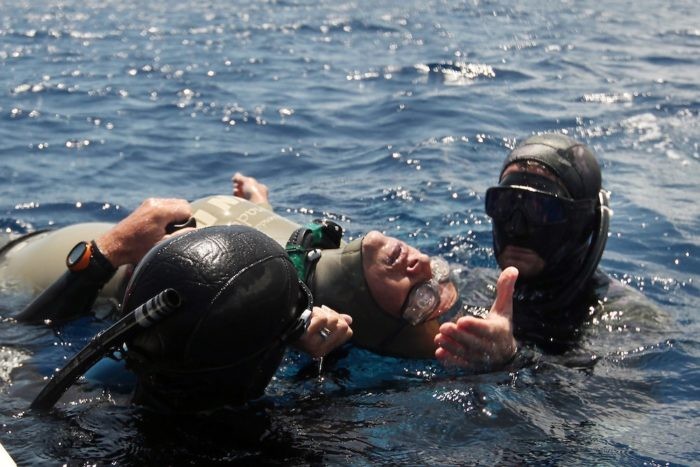 Freediver being rescued by competition safety divers after blacking out.