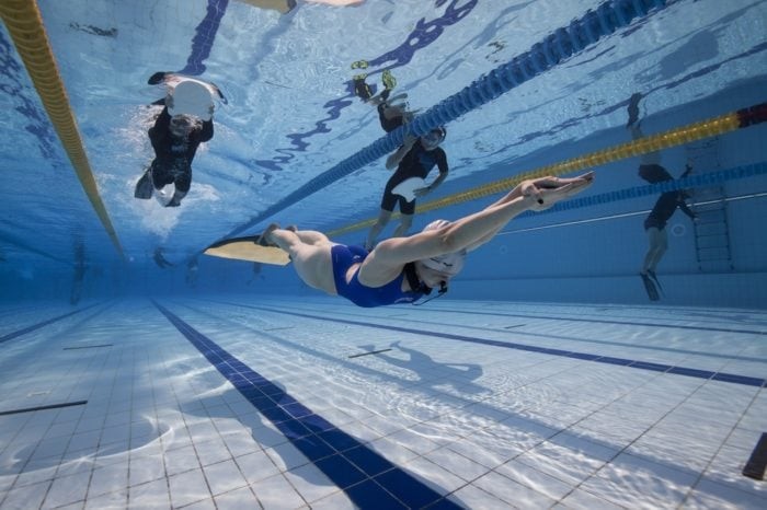 Freediver swimming in the Dynamic Pool Discipline with Safety on the surface