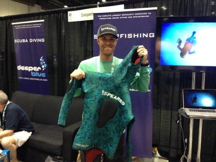 Speared Apparel's Aaron Chase shows off a prototype of his company's new spearfishing wetsuit