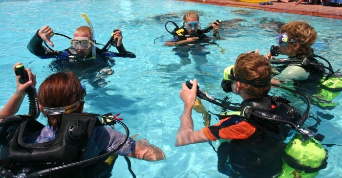 Instructor and students during scuba diving lessons