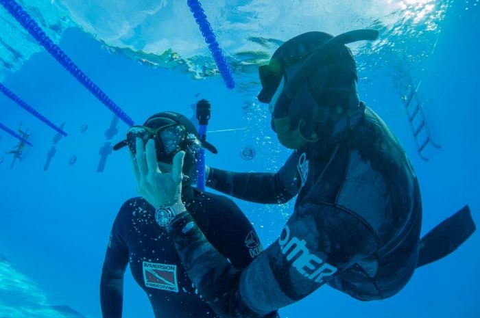 Students practice underwater rescue scenarios during a freediving course