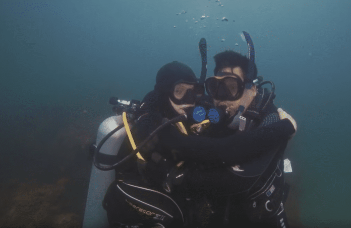 Retired USMC Sgt. Juan Gonzales diving with his son Marcus