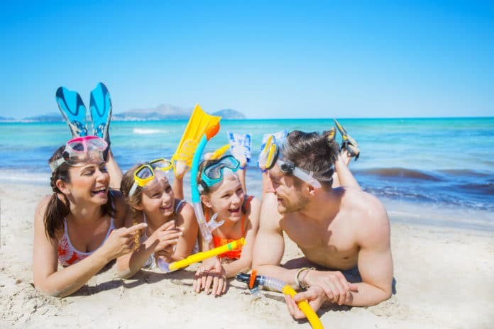 Family on the beach with snorkeling gear