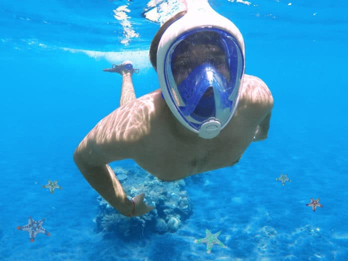 Snorkeling man in full face mask