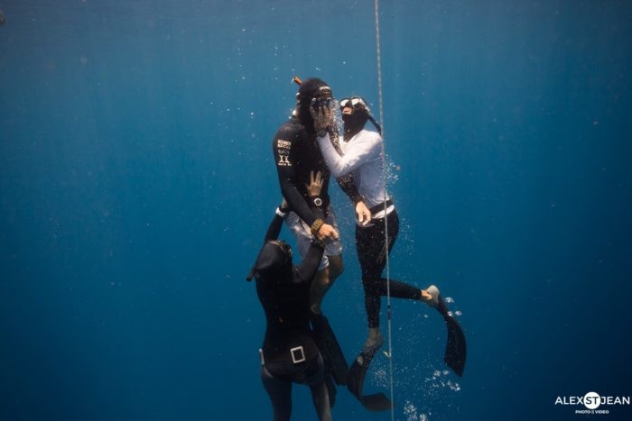 Rescue simulation performed by safety divers at a freediving competition.