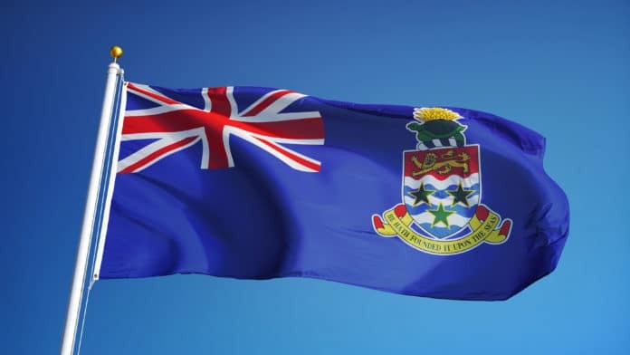 Cayman Islands flag waving against clean blue sky, close up,