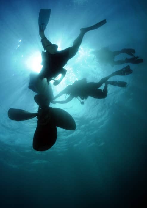  Divers use a lift bag system to move a sunken ship's propeller during an underwater lift - U.S. Navy photo 