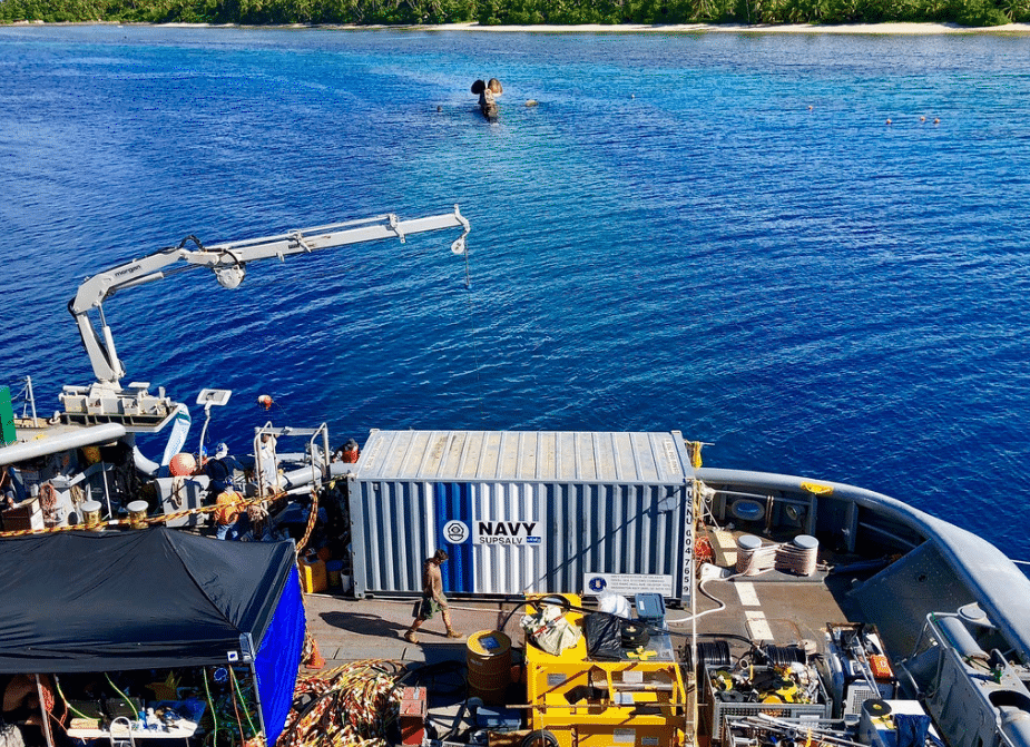 Divers and support personnel conduct recovery operations aboard the Military Sealift Command salvage ship USNS Salvor (T-ARS 52) while moored over the capsized World War II German heavy cruiser Prinz Eugen. (U.S. Navy photo)