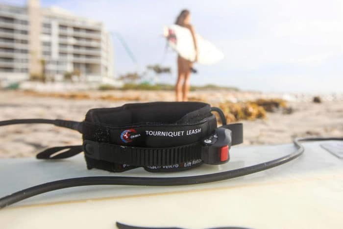 The OMNA tourniquet is wearable as a bracelet/anklet or surfboard leash.