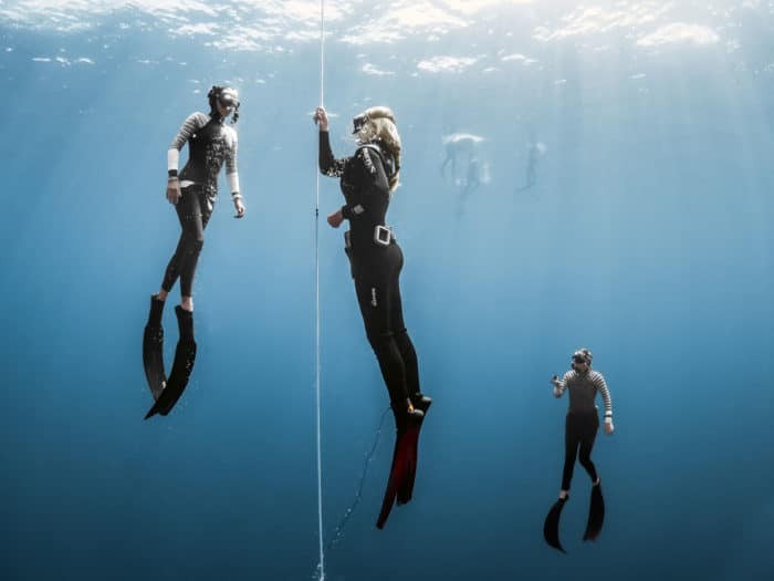 Freedivers line diving in Komodo.