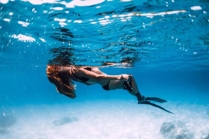 Woman freediver relaxing on the surface.
