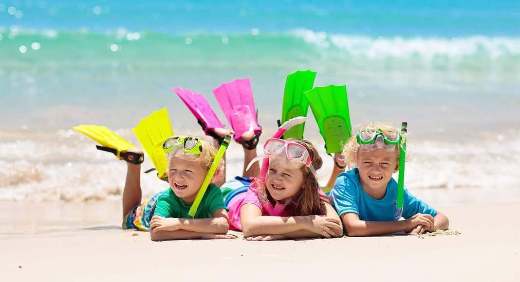 Kids snorkel. Beach fun. Children snorkeling in tropical sea on family summer vacation on exotic island. Child with mask and fins. Travel with young kid. Boy and girl learning to dive. Diving holiday.