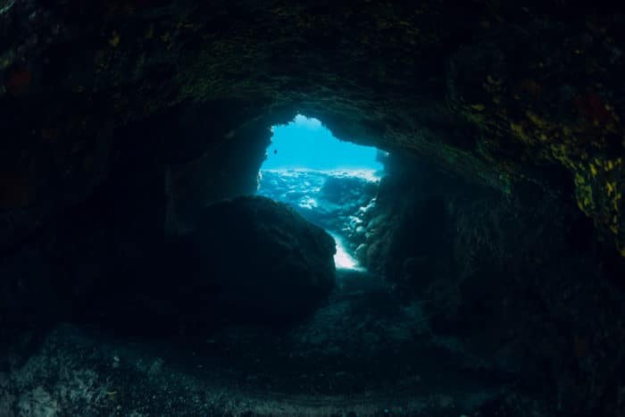 Underwater scene with tunnel cave in ocean