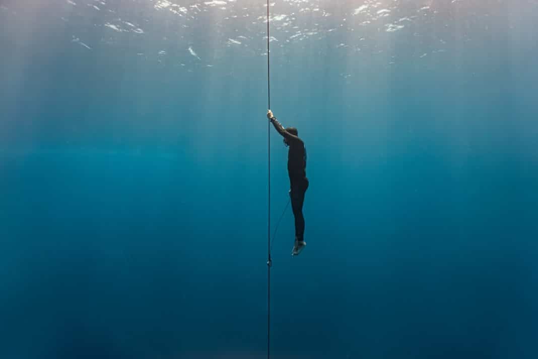 Freediver ascends to the surface by pulling the dive line