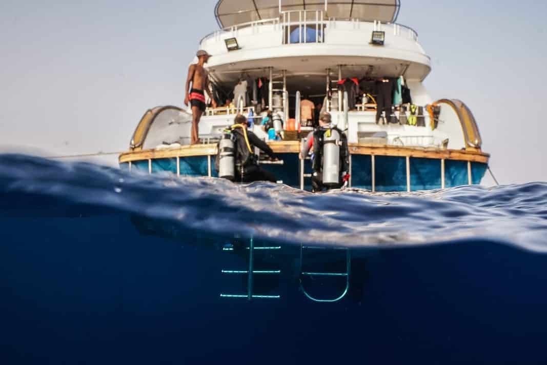 Scuba Divers getting back on a liveaboard after a dive in the Red Sea