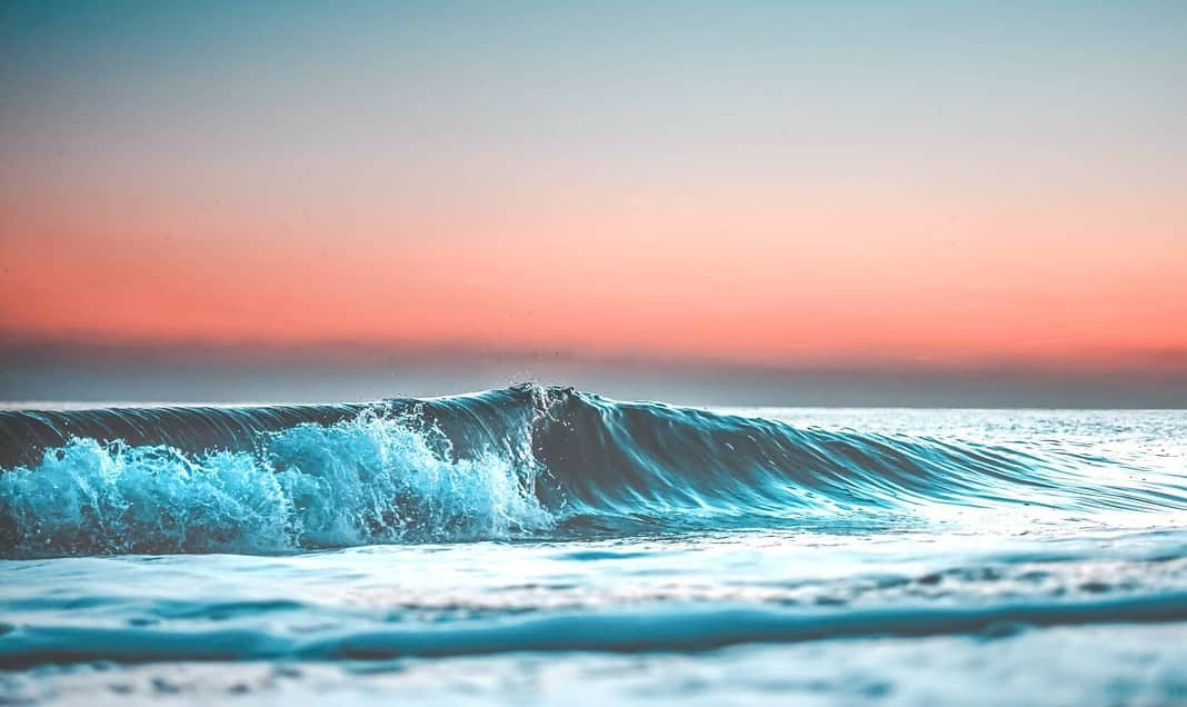 wave at sunset (Adobe Stock)