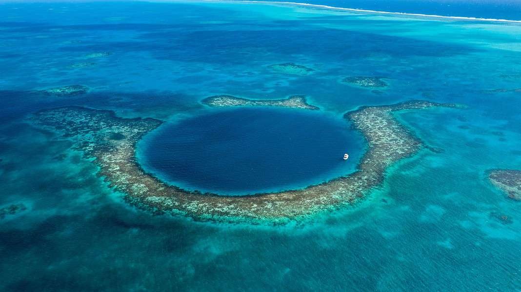 Aerial view of the Belize Blue Hole, UNESCO Heritage site to experience while Belize Scuba Diving