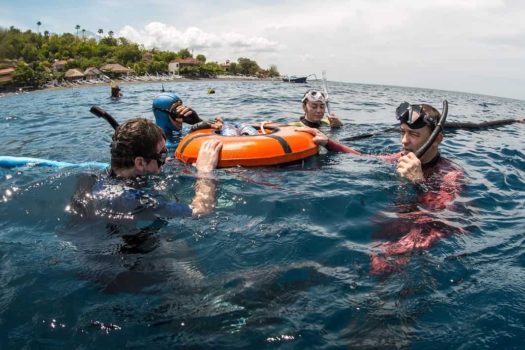 Freedivers training in the tropical sea near the coast, Amed, Indonesia