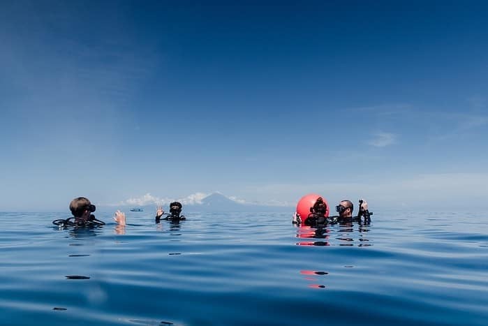 Planning your dive is critical to Scuba Diving Safety- people swimming on sea during daytime