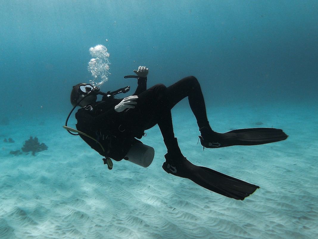 man with scuba diving insurance in scuba diving suit in water