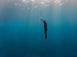 Freediver ascends to the surface by pulling the dive line